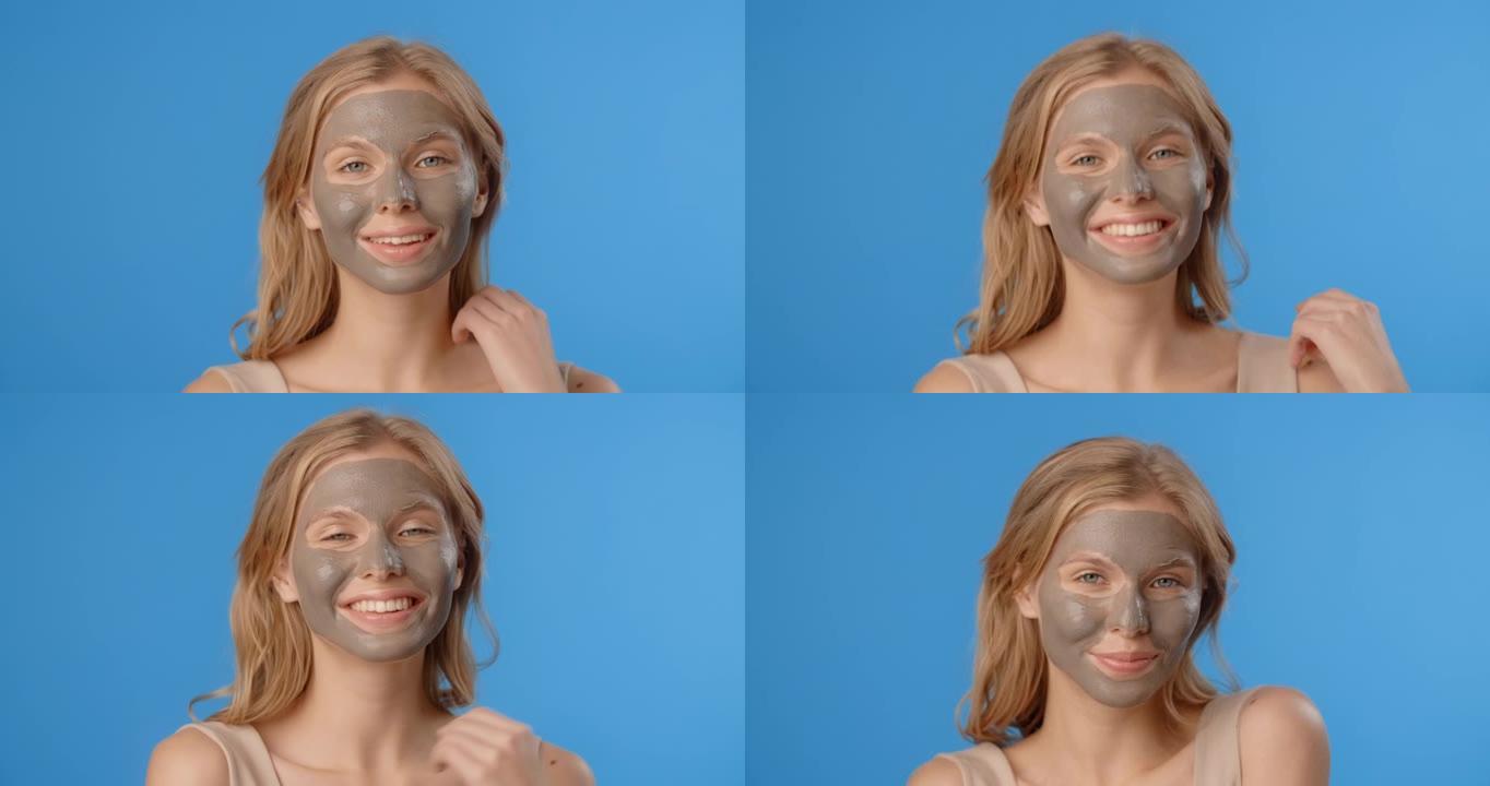 金发美女在应用粘土面罩中摆姿势。女性化妆品用法。4k proores总部蓝屏美容护理程序
