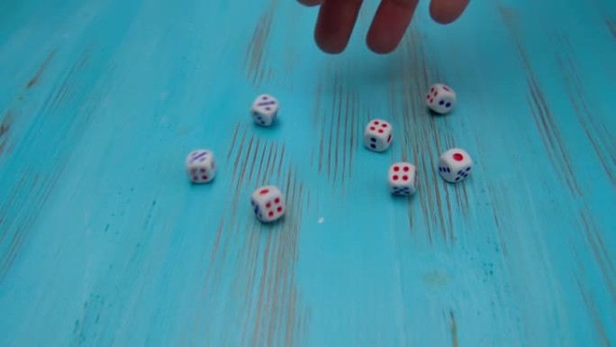 在蓝色的木制运动场上掷骰子。在线赌博的概念，赢家或玩家。