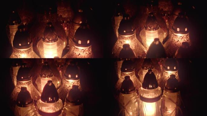墓地坟墓蜡烛灯笼被夜晚照亮。