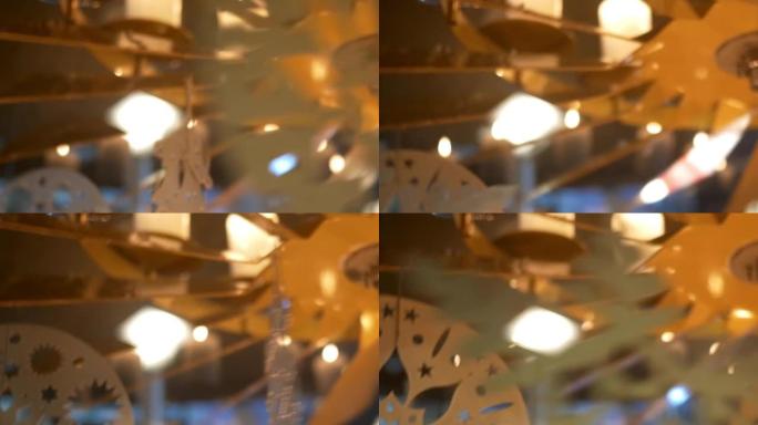 降临节白色蜡烛上的旋转装饰由胶合板制成，描绘天使或圣诞树09p1