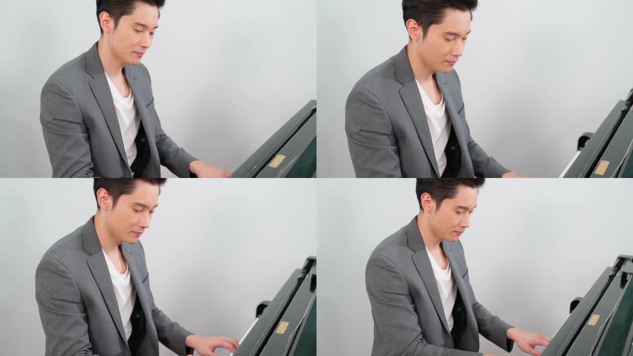 休闲风格的男钢琴家肖像在学校演奏经典三角钢琴。音乐家年轻人在练习钢琴时感到快乐和放松。在线音乐学校业