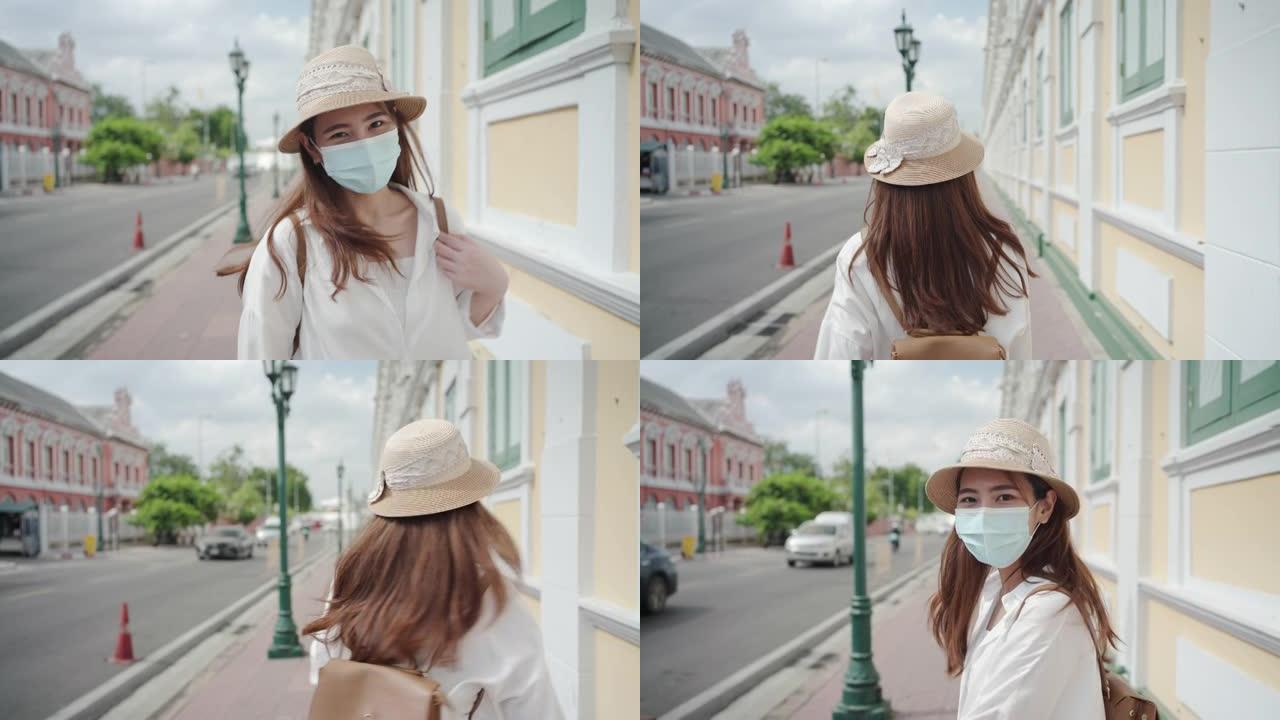 在泰国曼谷旅行时，戴着面具的亚洲女游客看起来很开心，微笑。