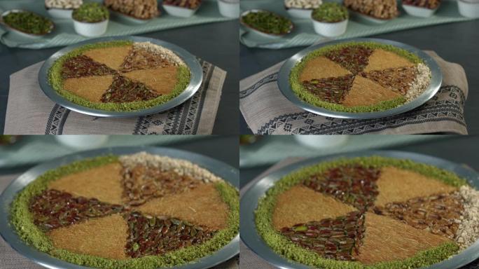 铜盘中的传统土耳其甜点kunefe。卡纳菲奶酪和开心果概念