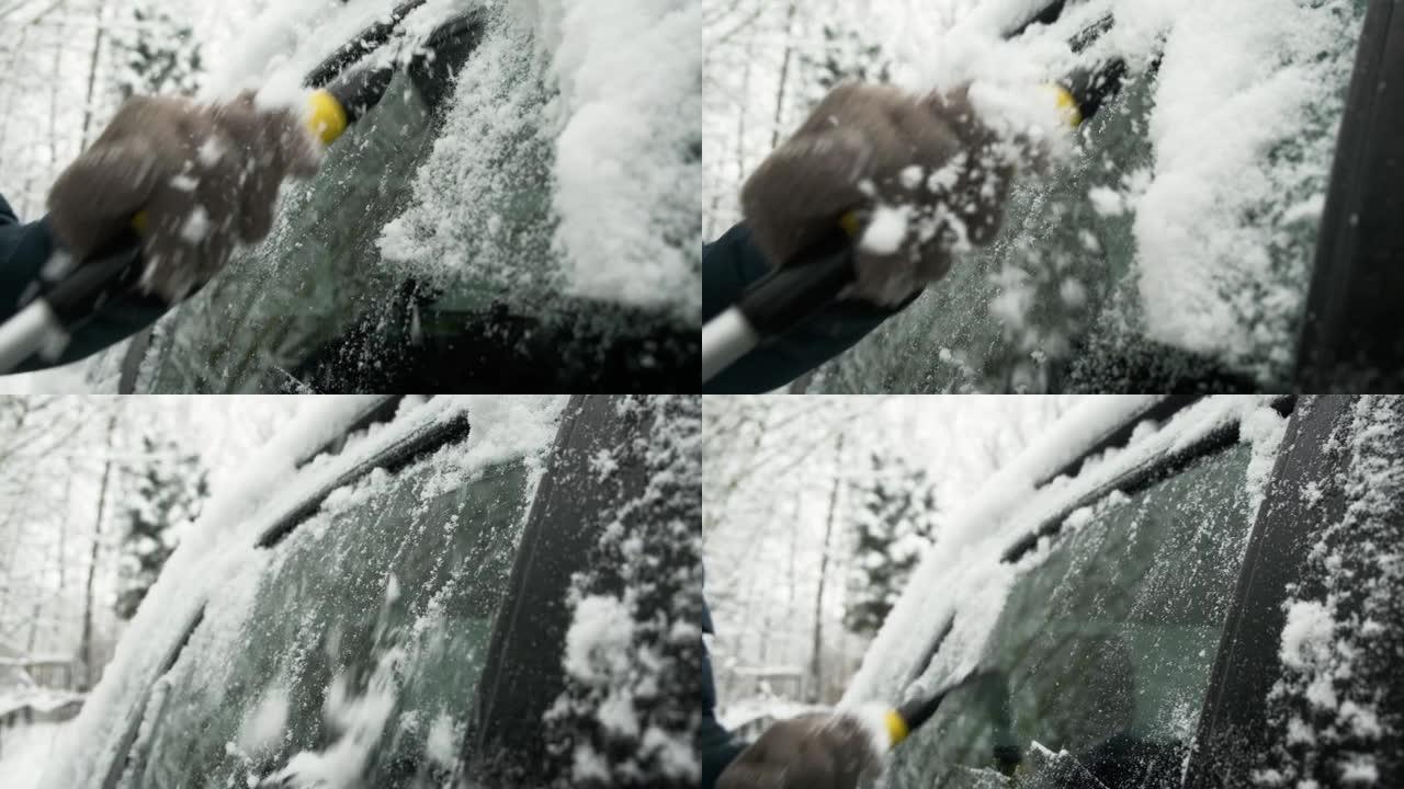 特写人员用废料从车窗上清除冰雪和冰冻的白霜。寒冷的冬季天气，自然灾害。暴风雪后打扫卫生的人刮擦了车。