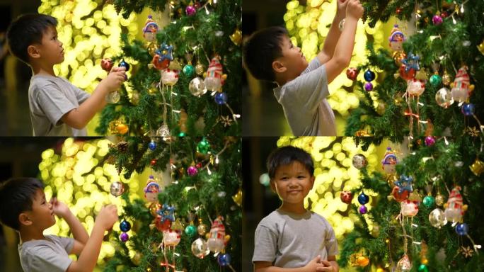 亚洲男孩用球装饰圣诞树