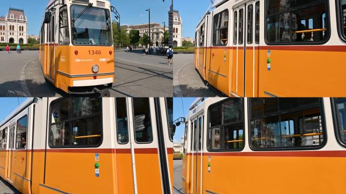 布达佩斯，匈牙利，2022年8月。漂亮的镜头，带有一个浅橙色老式电车的特写图像，该电车在城市中定期提