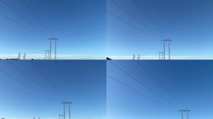 蓝天背景下的高压输电钢塔，城市电力塔和电线电缆为人们提供能源或电力，电力的传输和分配不间断