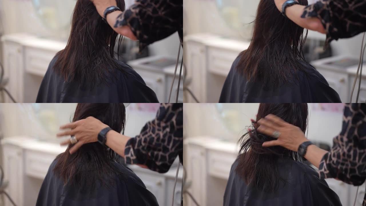 男性理发师用吹风机烘干女性头发