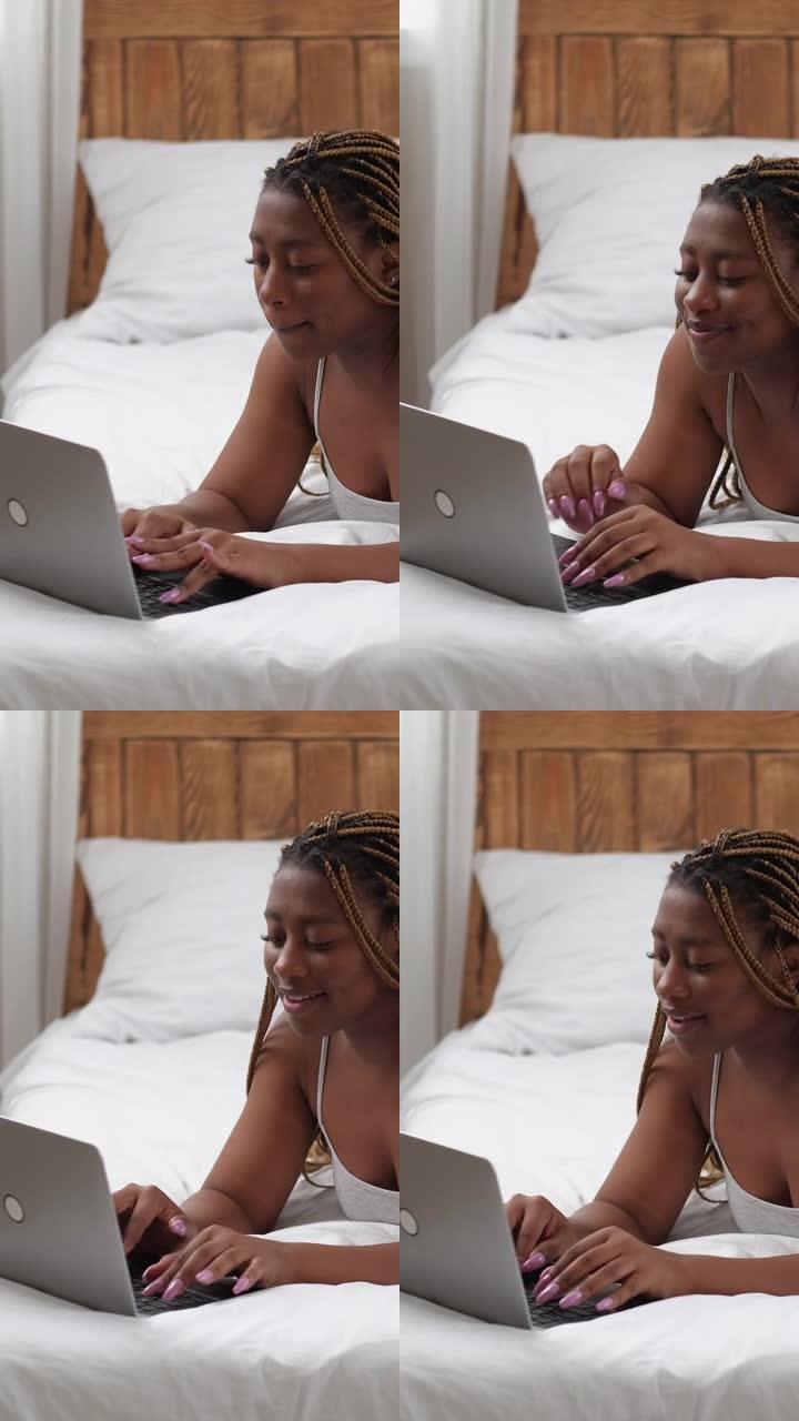 床上垂直视频虚拟聊天女人笔记本电脑