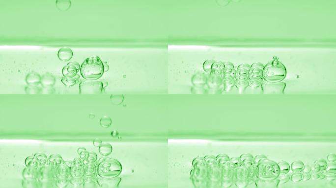 绿色气泡沉入绿色背景上的液体表面