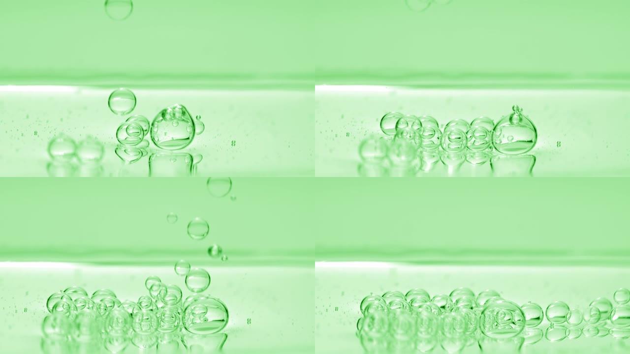 绿色气泡沉入绿色背景上的液体表面