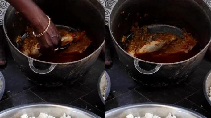 黑人妇女在3大碗米饭中添加鱼的中拍垂直视频