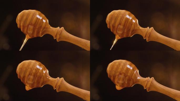 黑色背景下旋转的蜜勺与美味滴蜂蜜的静态拍摄