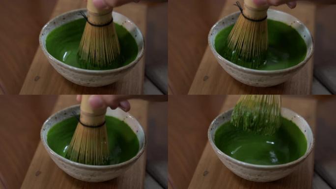 查森竹在碗里搅拌抹茶绿茶
