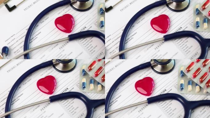 听诊器和红色玩具心脏躺在医疗文件特写4k电影慢动作