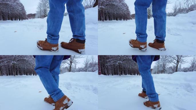 脚在雪地里。雪路上慢步莫的特写
