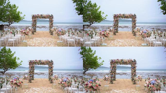 风景婚礼装饰金色椅子白布粉色鲜花仪式在海滩上。豪华目的地婚礼背景。
