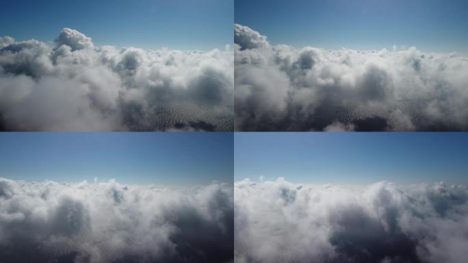 鸟瞰图。无人机飞过雾蒙蒙蓬松的云层。蓝天太阳和海雾。抽象空中自然夏季海洋日落海空背景。假期，假期和假