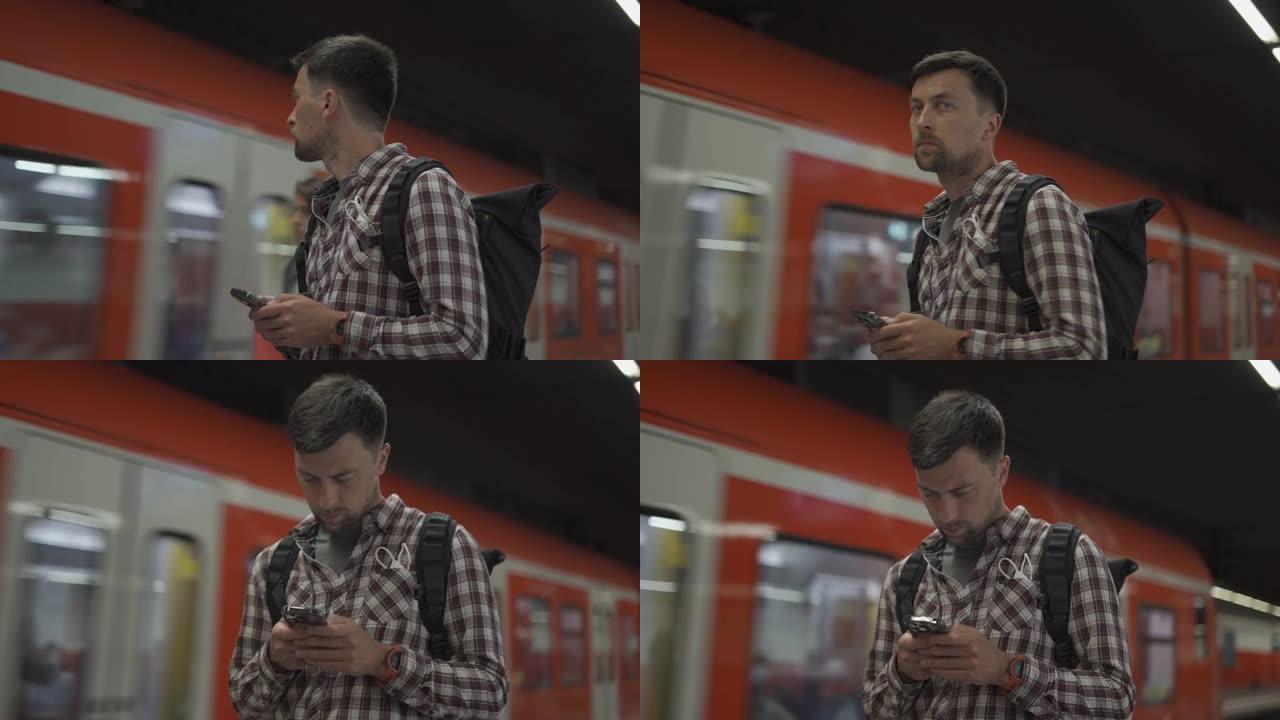 德国慕尼黑，一名男子在路过的火车前带着智能手机。带背包的乘客使用电话创建路线图并在线购买机票。S-B