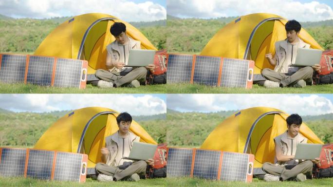 4K，年轻的旅行家放松，享受露营。便携式太阳能电池板用多功能电缆为笔记本电脑充电，清洁能源，用于野营