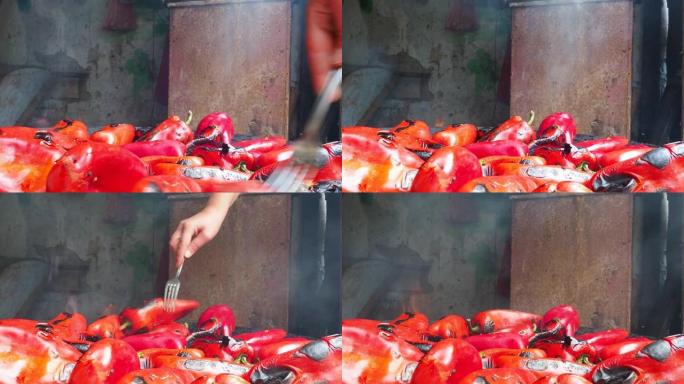 烤红辣椒，具有烟熏味和快速脱皮。辣椒作物在金属圈上的热处理。火盆容器，用于燃烧木炭燃料进行烹饪或加热
