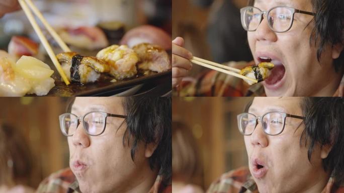 第一次尝试吃unagi寿司并微笑，但由于口味异常而颤抖。