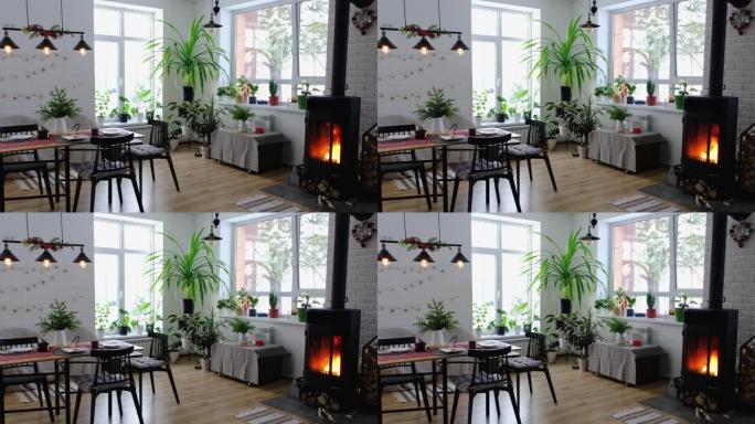 黑色炉子，阁楼风格的房子内部壁炉。替代环保供暖，家里温暖舒适的房间，燃烧木材
