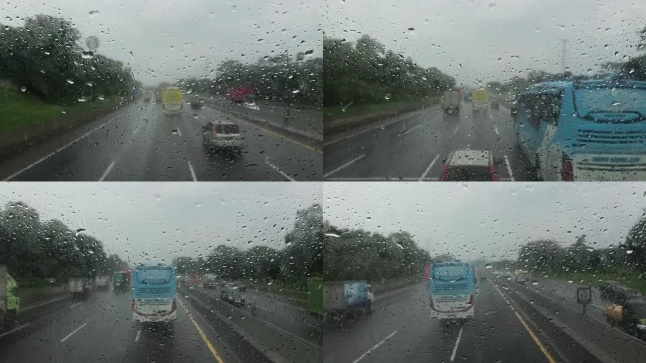 在印度尼西亚的雨和冰雹中，模糊的汽车前视图在高速公路上行驶。
