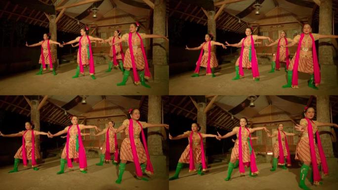 节日在村庄内开始时，爪哇人穿着橙色连衣裙和绿色围巾一起跳舞