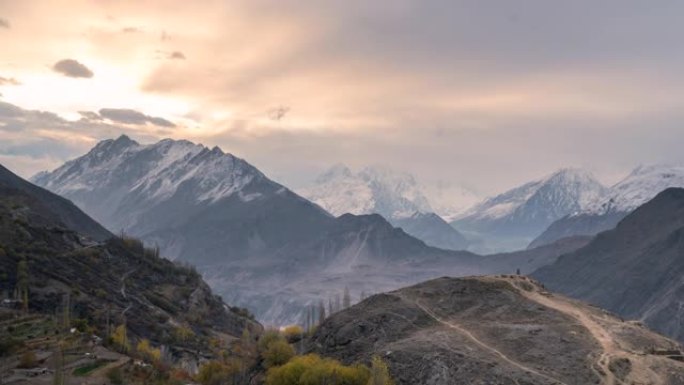 秋天在巴基斯坦的罕萨谷，喀喇昆仑山山脉的雪山壮丽景色的延时移动云日出场景