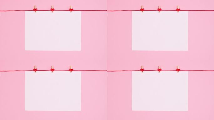 情人节贺卡，用心挂在红绳上的复印空间纸。停止运动