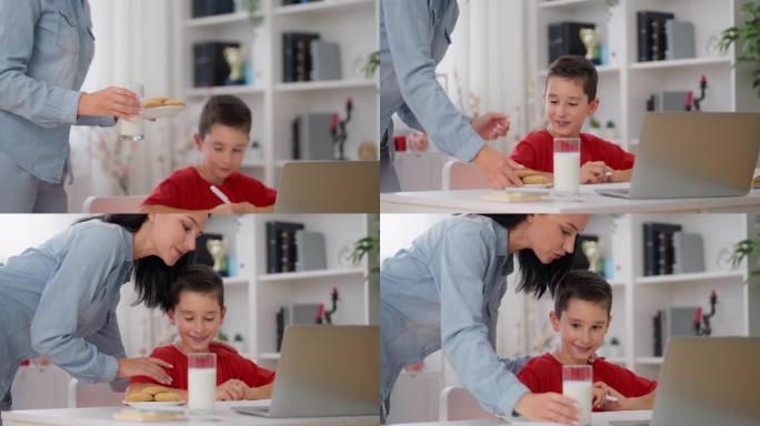 妈妈带牛奶和饼干给儿子在家学习，健康的饮食习惯