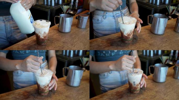 咖啡师在玻璃杯中倒入杯子并制作冰拿铁的特写镜头