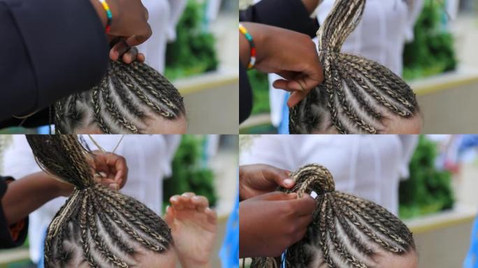 非洲理发师领带细辫子把所有的头编成高紧的尾巴