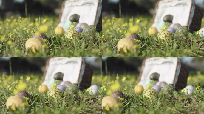 装饰好的复活节彩蛋已经从篮子里掉了出来，黄花躺在草地上。特写，全景。