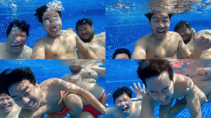 三个亚洲游客在度假胜地游泳池里一起在水下写博客，看着相机