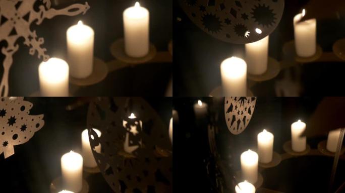 降临节白色蜡烛上的旋转装饰由胶合板制成，描绘天使或圣诞树11p2