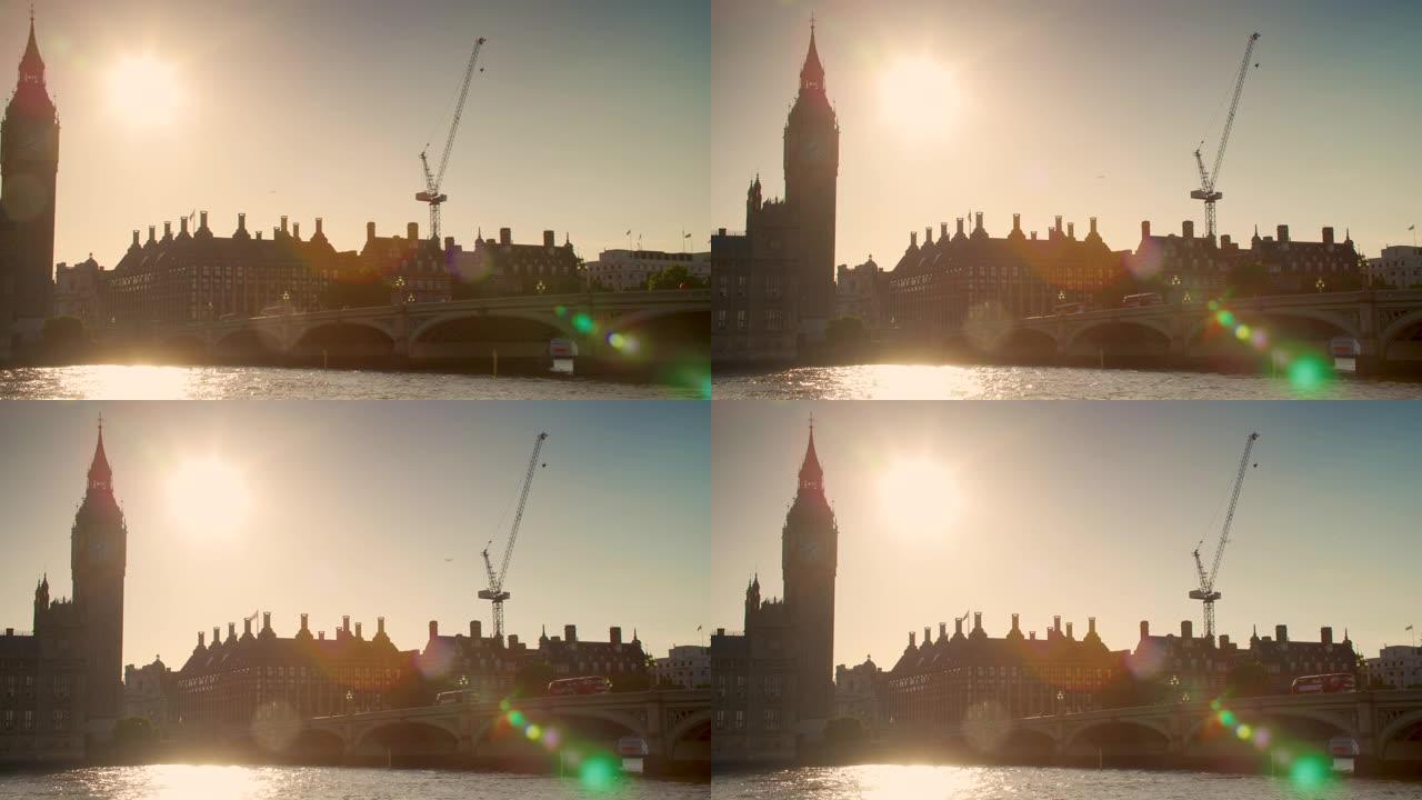 日落时分，大笨钟和英国伦敦国会大厦穿越威斯敏斯特桥的人和红色巴士