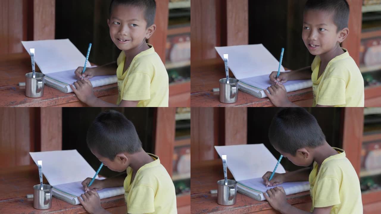 尼泊尔男孩在安纳普尔纳山脉附近的村庄做作业