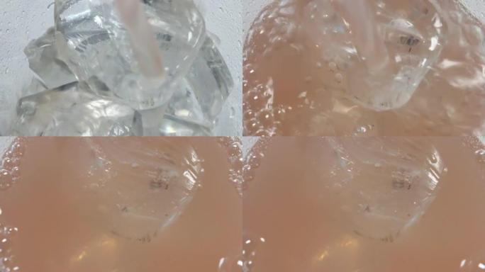 苏打水倒入装有冰的玻璃杯中的特写镜头