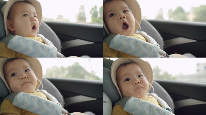 可爱的亚洲小男孩坐在汽车座椅上