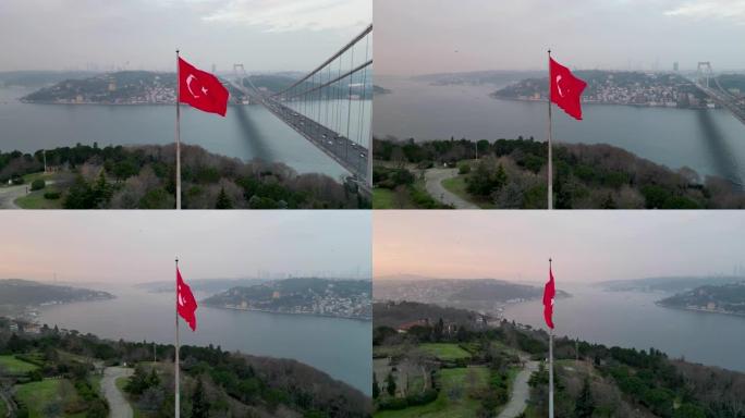 日出时在伊斯坦布尔博斯普鲁斯大桥前挥舞着土耳其国旗的鸟瞰图4k无人机镜头