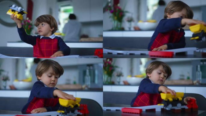 孩子在家玩玩具。2岁的孩子穿着毛衣玩火车物体。顽皮的小孩做梦