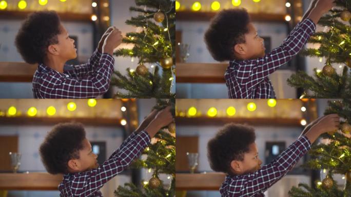 可爱的非裔美国男孩在圣诞节前在家装饰树的肖像