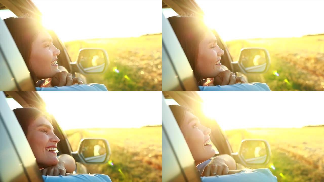 快乐的年轻女子看着窗外金色的夕阳在田野里唱着歌
