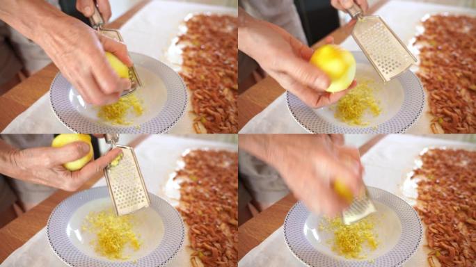 双手在磨碎机上摩擦柠檬皮，用于苹果馅饼