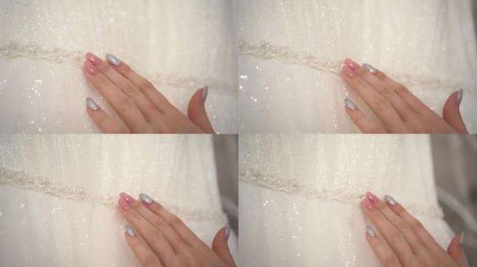 新娘用手抚摸婚纱
