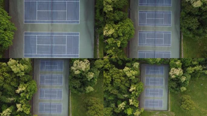绿树环绕的网球场的无人机视图