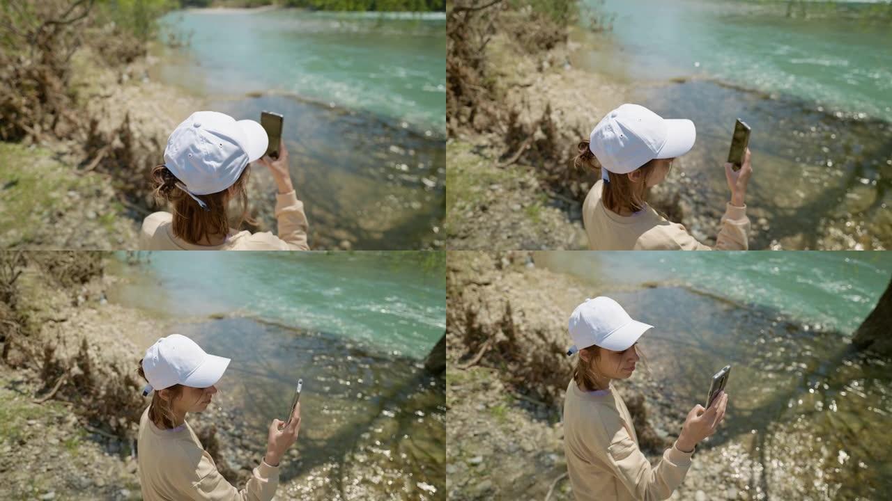 科普鲁鲁峡谷山河岸上的女游客获得全景照片。Koprulu峡谷是土耳其常见的旅游胜地。女孩用手机相机拍