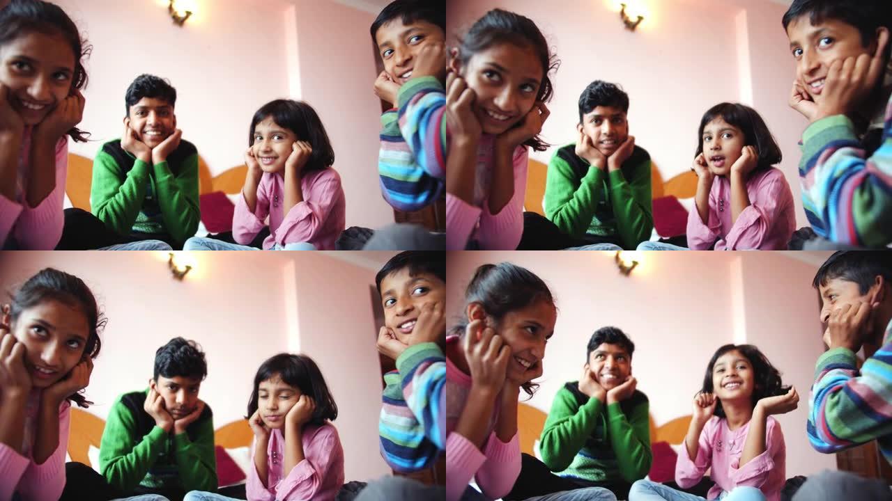 四个南亚孩子坐在卧室里在印度玩耍的低角度镜头